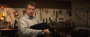 Movie still from “The House” (2017), directed by Andrew Jay Cohen – A man holding a suit jacket in his hands; Medium shot, Over the shoulder angle