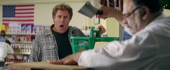 Movie still from “The House” (2017), directed by Andrew Jay Cohen – A man with an angry look on his face holding a knife in his hand; Medium shot, Over the shoulder angle