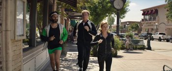 Movie still from “The House” (2017), directed by Andrew Jay Cohen – A group of people walking down a sidewalk; Wide shot, Over the shoulder angle
