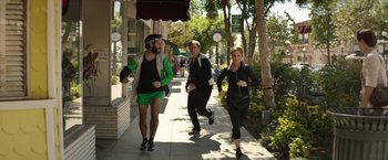 Movie still from “The House” (2017), directed by Andrew Jay Cohen – A group of people walking down a sidewalk; Wide shot, Over the shoulder angle