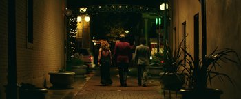 Movie still from “The House” (2017), directed by Andrew Jay Cohen – A group of people walking down a sidewalk at night; Wide shot, Low angle