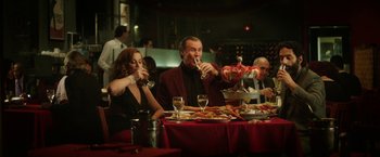 Movie still from “The House” (2017), directed by Andrew Jay Cohen – A group of people sitting at a table drinking wine; Medium shot, Over the shoulder angle