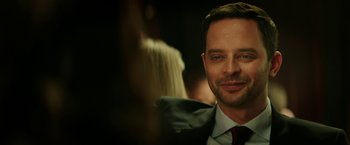 Movie still from “The House” (2017), directed by Andrew Jay Cohen – A person wearing a suit and tie; Close Up shot, Over the shoulder angle
