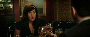 Movie still from “The House” (2017), directed by Andrew Jay Cohen – A woman sitting in front of three glasses of wine; Close Up shot, Over the shoulder angle