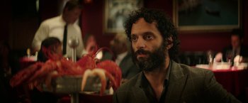 Movie still from “The House” (2017), directed by Andrew Jay Cohen – A man sitting in front of a lobster in a restaurant; Close Up shot, Over the shoulder angle