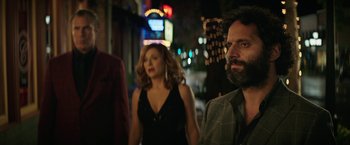 Movie still from “The House” (2017), directed by Andrew Jay Cohen – A group of people walking down a street at night; Medium shot, Over the shoulder angle