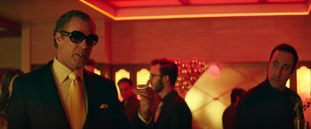 Movie still from “The House” (2017), directed by Andrew Jay Cohen – A group of people standing in a room; Medium shot, Low angle