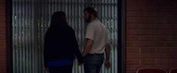 Movie still from “The House” (2017), directed by Andrew Jay Cohen – A man and a woman holding hands while standing next to each other; Medium shot, Over the shoulder angle
