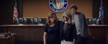 Movie still from “The House” (2017), directed by Andrew Jay Cohen – Two women and a man standing in front of a fox meadow sign; Medium shot, Over the shoulder angle