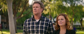 Movie still from “The House” (2017), directed by Andrew Jay Cohen – A man and a woman standing next to each other in front of trees; Medium shot, Over the shoulder angle