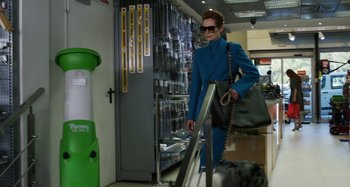 Movie still from “The Human Voice” (2020), directed by Pedro Almodóvar – A woman in a blue suit is walking down the street; Wide shot, Low angle