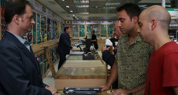 Movie still from “The Human Voice” (2020), directed by Pedro Almodóvar – A group of people sitting around in a store; Medium shot, Over the shoulder angle