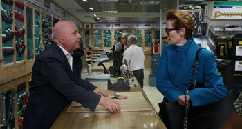 Movie still from “The Human Voice” (2020), directed by Pedro Almodóvar – A man and a woman talking to each other in a store; Medium shot, Over the shoulder angle