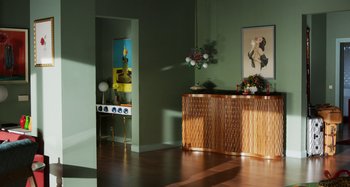 Movie still from “The Human Voice” (2020), directed by Pedro Almodóvar – A living room with a wooden cabinet and a painting on the wall; Extreme Wide shot, High angle