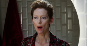 Movie still from “The Human Voice” (2020), directed by Pedro Almodóvar – Tilda swinton in a red and black floral shirt; Close Up shot, Over the shoulder angle