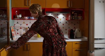 Movie still from “The Human Voice” (2020), directed by Pedro Almodóvar – A woman standing in a kitchen preparing a meal; Medium shot, Over the shoulder angle