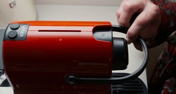 Movie still from “The Human Voice” (2020), directed by Pedro Almodóvar – A person is holding a toaster in their hand; Extreme Close Up shot, Overhead angle