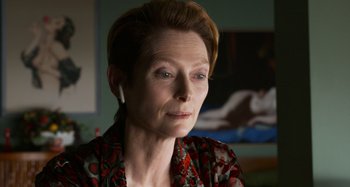 Movie still from “The Human Voice” (2020), directed by Pedro Almodóvar – A woman wearing a red and white floral shirt; Close Up shot, Over the shoulder angle