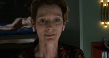 Movie still from “The Human Voice” (2020), directed by Pedro Almodóvar – A person wearing a red and black shirt; Close Up shot, Low angle