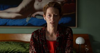 Movie still from “The Human Voice” (2020), directed by Pedro Almodóvar – A woman in a red shirt and a red jacket; Close Up shot, Over the shoulder angle