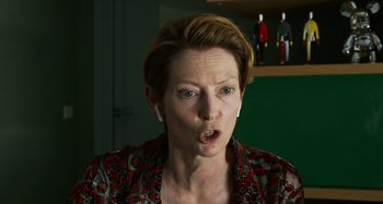 Movie still from “The Human Voice” (2020), directed by Pedro Almodóvar – A person wearing headphones with their mouth wide open; Close Up shot, Over the shoulder angle