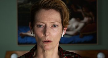 Movie still from “The Human Voice” (2020), directed by Pedro Almodóvar – A person with short brown hair; Close Up shot, Over the shoulder angle