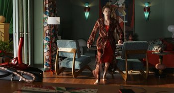 Movie still from “The Human Voice” (2020), directed by Pedro Almodóvar – A woman in a red dress is walking on the floor; Wide shot, High angle