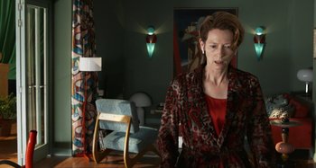 Movie still from “The Human Voice” (2020), directed by Pedro Almodóvar – A woman standing in front of a painting in a living room; Medium shot, Low angle