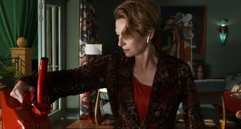 Movie still from “The Human Voice” (2020), directed by Pedro Almodóvar – A woman in a red shirt and a red and black jacket; Medium shot, Low angle