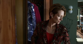 Movie still from “The Human Voice” (2020), directed by Pedro Almodóvar – A woman in a red and black jacket looking at a mirror; Close Up shot, Over the shoulder angle