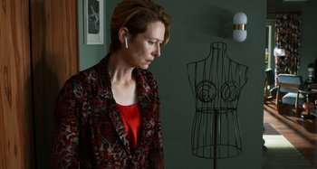 Movie still from “The Human Voice” (2020), directed by Pedro Almodóvar – A woman standing in front of a dress form; Medium shot, Over the shoulder angle