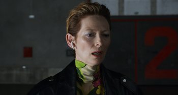 Movie still from “The Human Voice” (2020), directed by Pedro Almodóvar – A woman with short brown hair wearing a leather jacket; Close Up shot, Over the shoulder angle