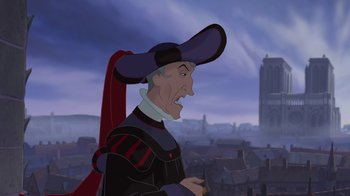 Movie still from “The Hunchback of Notre Dame” (1996), directed by Gary Trousdale – A cartoon of a man with a hat on; Close Up shot, Over the shoulder angle