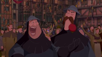 Movie still from “The Hunchback of Notre Dame” (1996), directed by Gary Trousdale – Two men in medieval garb are laughing together in front of a crowd of onlookers; Medium shot, Over the shoulder angle