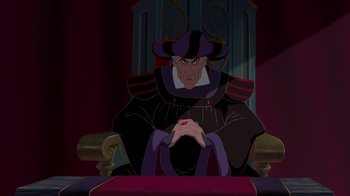 Movie still from “The Hunchback of Notre Dame” (1996), directed by Gary Trousdale – A man sitting in a chair with his hands on his knees; Medium shot, Over the shoulder angle