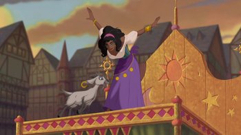 Movie still from “The Hunchback of Notre Dame” (1996), directed by Gary Trousdale – An animated scene of a woman and a goat; Wide shot, Low angle