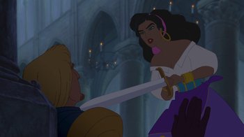 Movie still from “The Hunchback of Notre Dame” (1996), directed by Gary Trousdale – A woman holding a sword in front of a man in front of a building; Medium shot, Over the shoulder angle