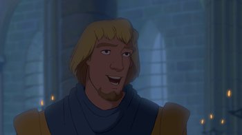 Movie still from “The Hunchback of Notre Dame” (1996), directed by Gary Trousdale – A man with blonde hair and a beard is smiling for the camera; Close Up shot, Over the shoulder angle