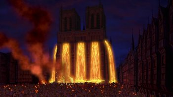 Movie still from “The Hunchback of Notre Dame” (1996), directed by Gary Trousdale – A large fire is burning in front of a building; Extreme Wide shot, Low angle