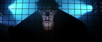 Movie still from “The Hunger” (1983), directed by Tony Scott – A man with his mouth wide open in front of a wall; Close Up shot, Low angle