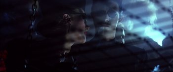 Movie still from “The Hunger” (1983), directed by Tony Scott – A woman and a man looking out of a window; Close Up shot, Low angle