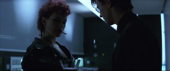 Movie still from “The Hunger” (1983), directed by Tony Scott – A man and a woman standing next to each other in a dark room; Close Up shot, Low angle