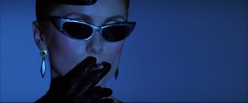 Movie still from “The Hunger” (1983), directed by Tony Scott – A woman wearing sunglasses and a black leather glove; Close Up shot, Low angle