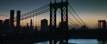 Movie still from “The Hunger” (1983), directed by Tony Scott – A view of a bridge with a city in the background; Extreme Wide shot, Low angle