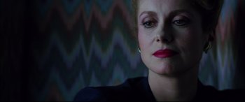 Movie still from “The Hunger” (1983), directed by Tony Scott – A person wearing a black shirt; Close Up shot, Low angle