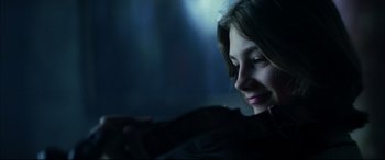 Movie still from “The Hunger” (1983), directed by Tony Scott – A woman looking at her cell phone in the dark; Close Up shot, Over the shoulder angle