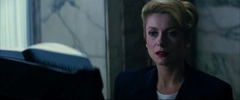 Movie still from “The Hunger” (1983), directed by Tony Scott – A person with short blonde hair; Close Up shot, Low angle