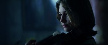 Movie still from “The Hunger” (1983), directed by Tony Scott – A girl is looking into the distance while holding a violin; Close Up shot, Low angle