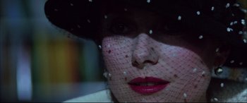 Movie still from “The Hunger” (1983), directed by Tony Scott – A person wearing a veil; Extreme Close Up shot, Over the shoulder angle