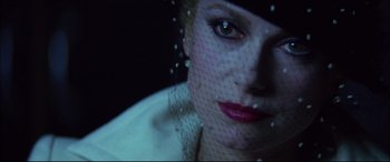 Movie still from “The Hunger” (1983), directed by Tony Scott – A person wearing a veil; Close Up shot, Over the shoulder angle